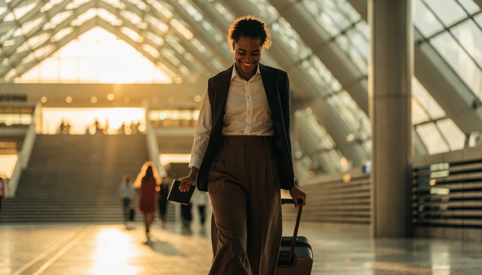 A professional arriving at Dubai airport holding a passport